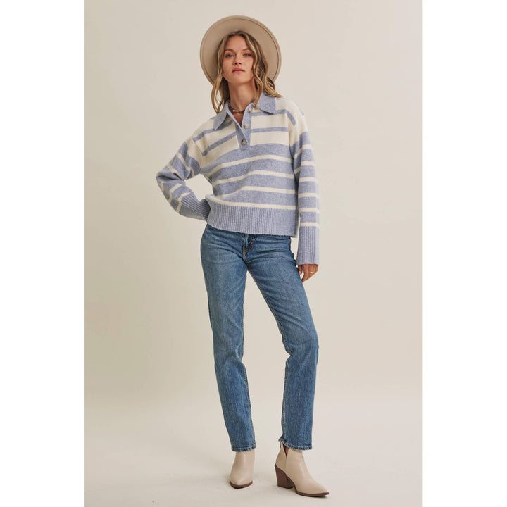 Woman wearing The Marlowe ice blue and ivory striped brushed Henley sweater with blue jeans