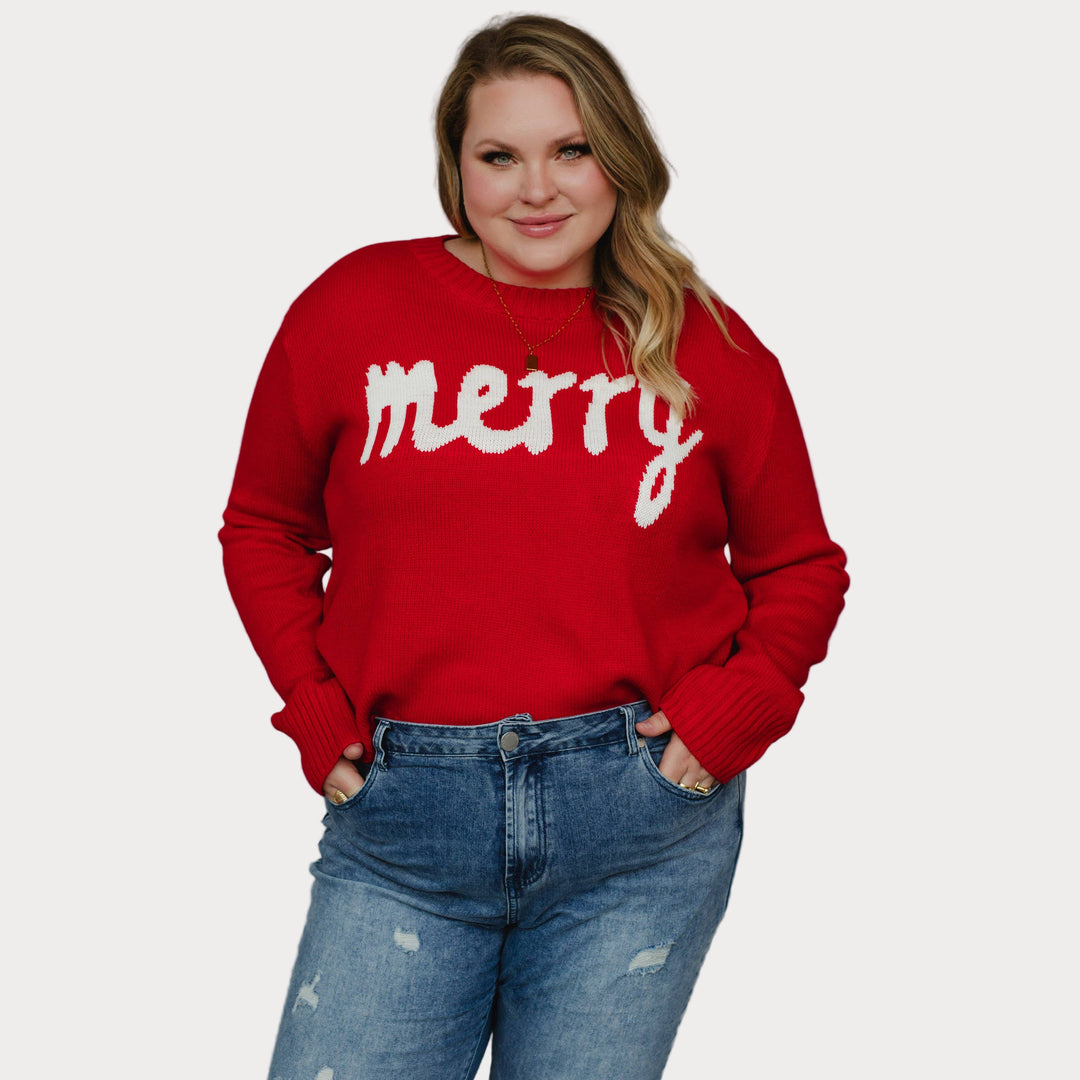 Plus size model wearing a red sweater with 'merry' text against a neutral background