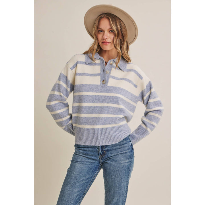 Woman wearing The Marlowe ice blue and ivory striped brushed Henley sweater with blue jeans
