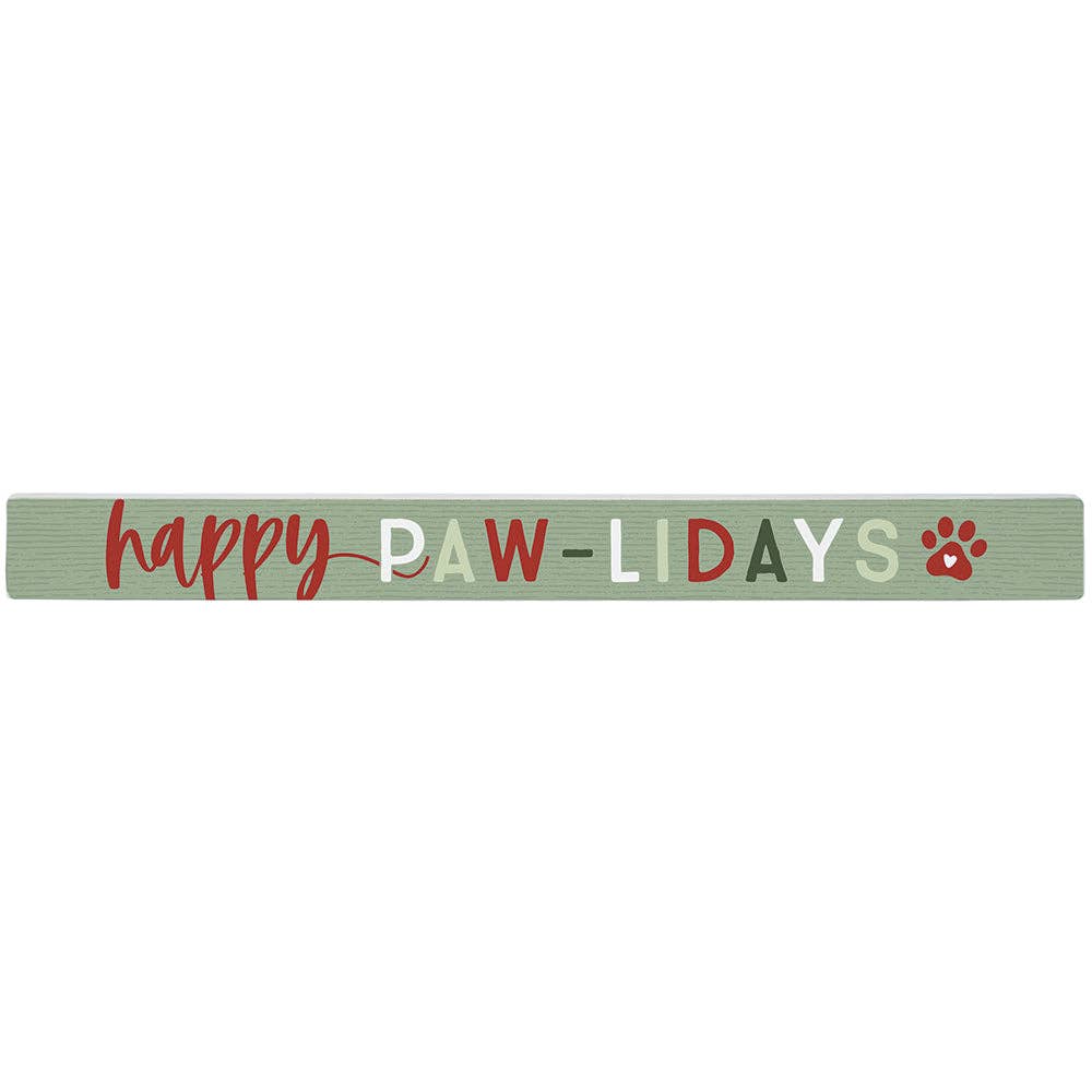green wooden sign with the words “happy paw-lidays” and red paw print
