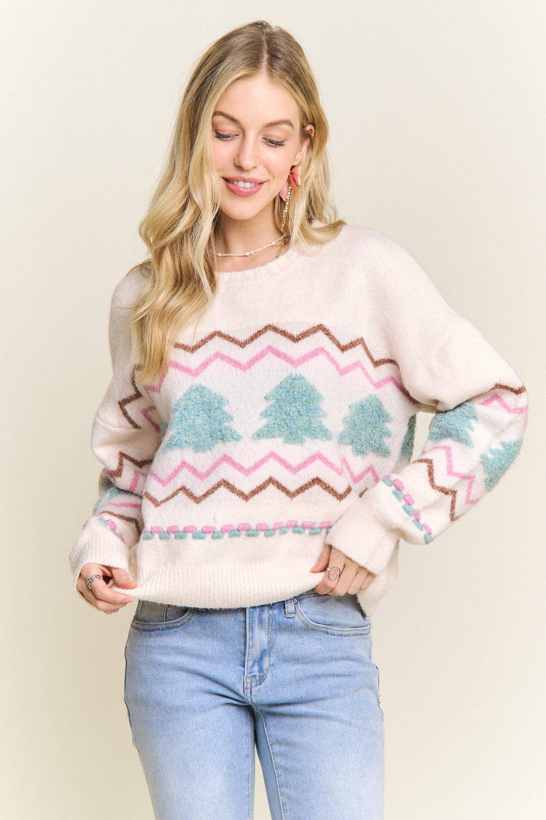“Cream knit sweater with fluffy textured Christmas trees and pastel chevron stripes”