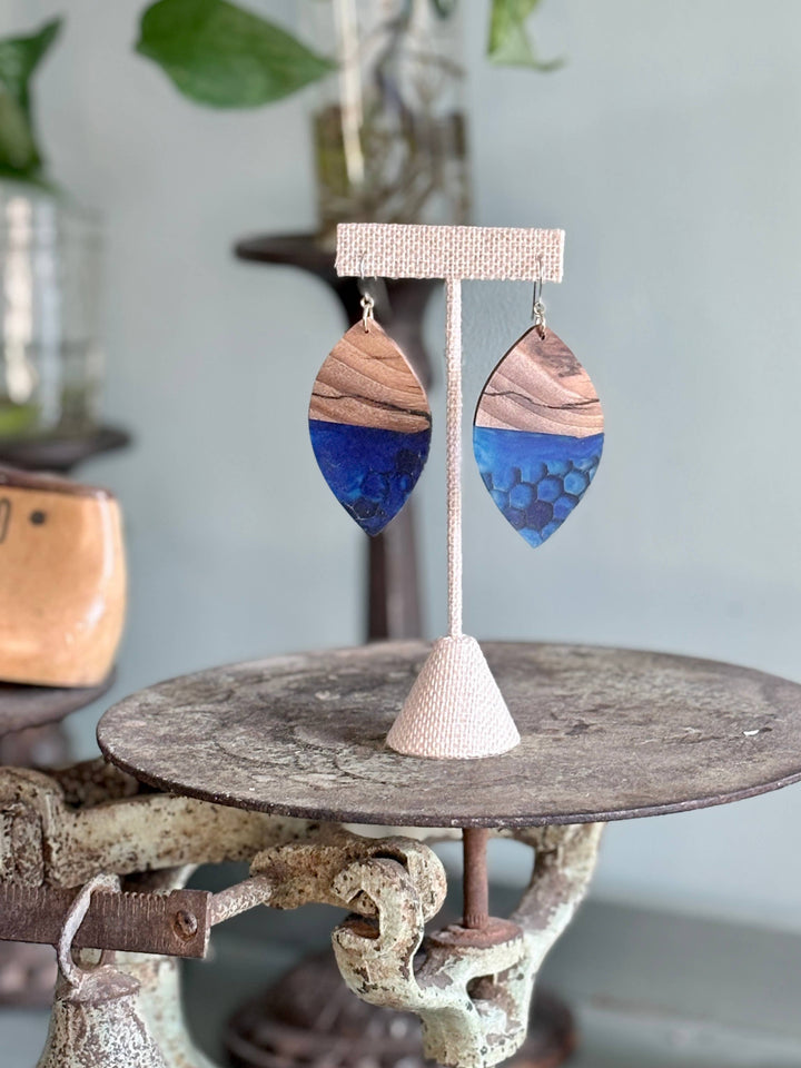 Handcrafted Indigo Hive Wood Earrings featuring natural wood grain and deep indigo resin with honeycomb detailing and hypoallergenic stainless-steel hooks.