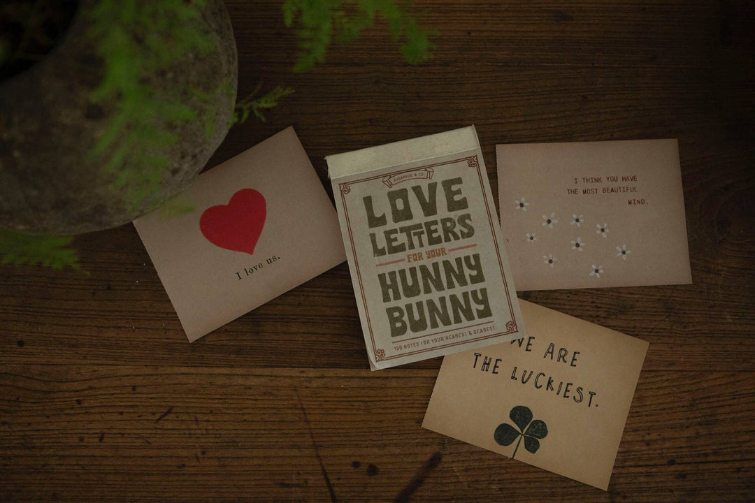 Love Letters for Your Hunny Bunny tear-out note book by Sugarboo & Co. on a wooden surface with props