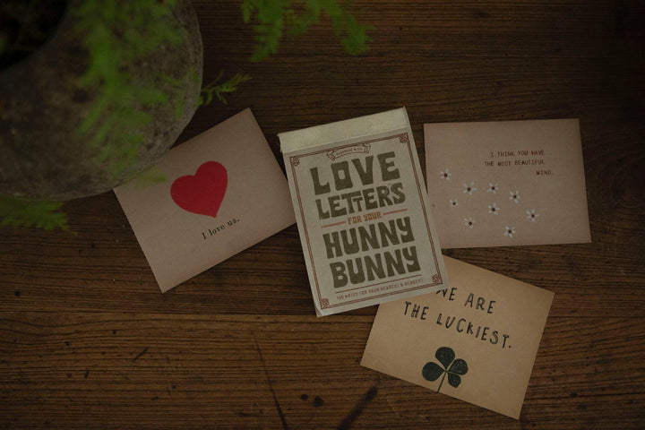 Love Letters for Your Hunny Bunny tear-out note book by Sugarboo & Co. on a wooden surface with props