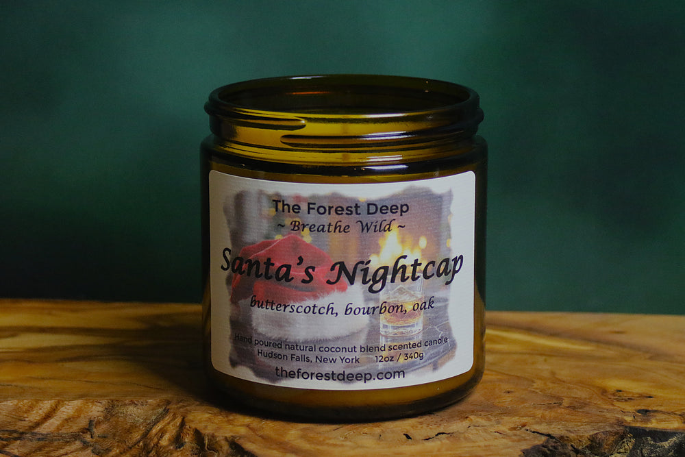 “Santa’s Nightcap candle by The Forest Deep with bourbon and butterscotch holiday label”