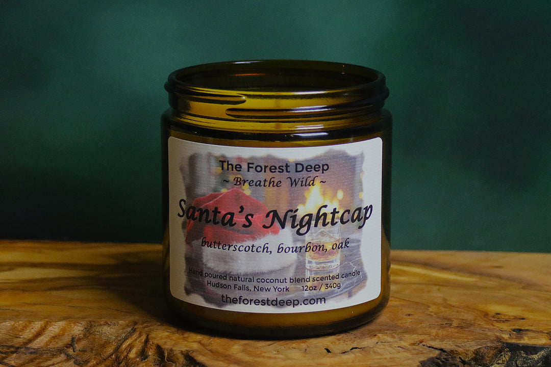 “Santa’s Nightcap candle by The Forest Deep with bourbon and butterscotch holiday label”