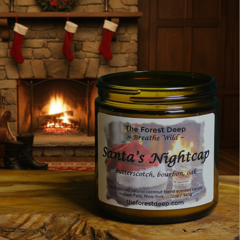 Candle labeled 'Santa's Nightcap' in front of a fireplace with Christmas stockings.
