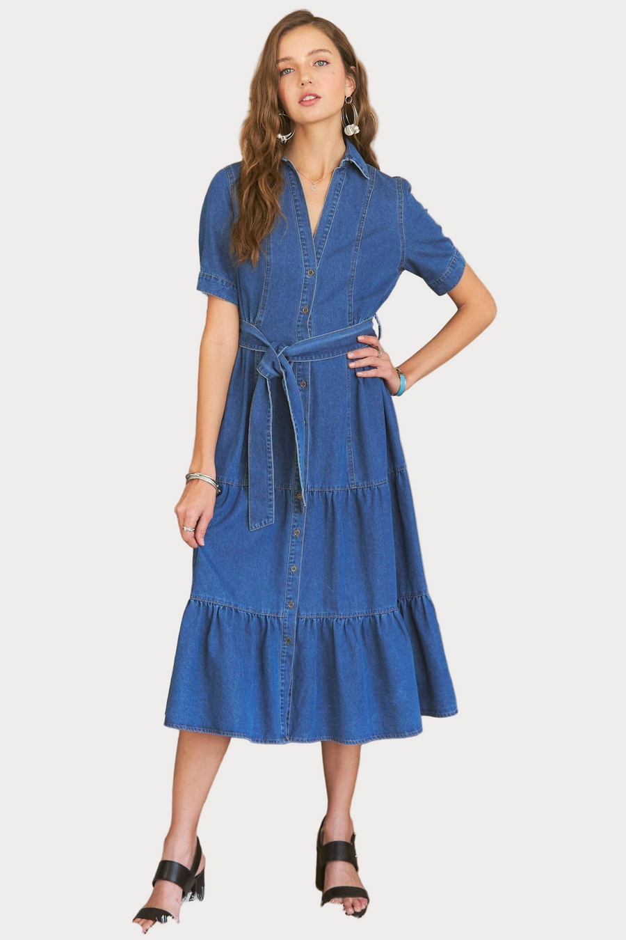 Women wearing a denim tie waist tiered, button down dress