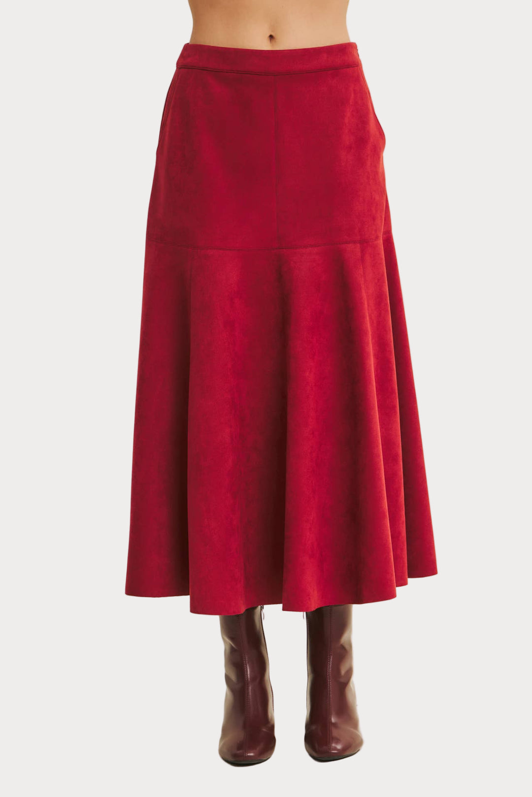 Red skirt worn by a person on a beige background