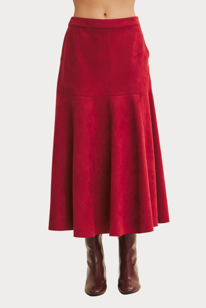Red skirt worn by a person on a beige background
