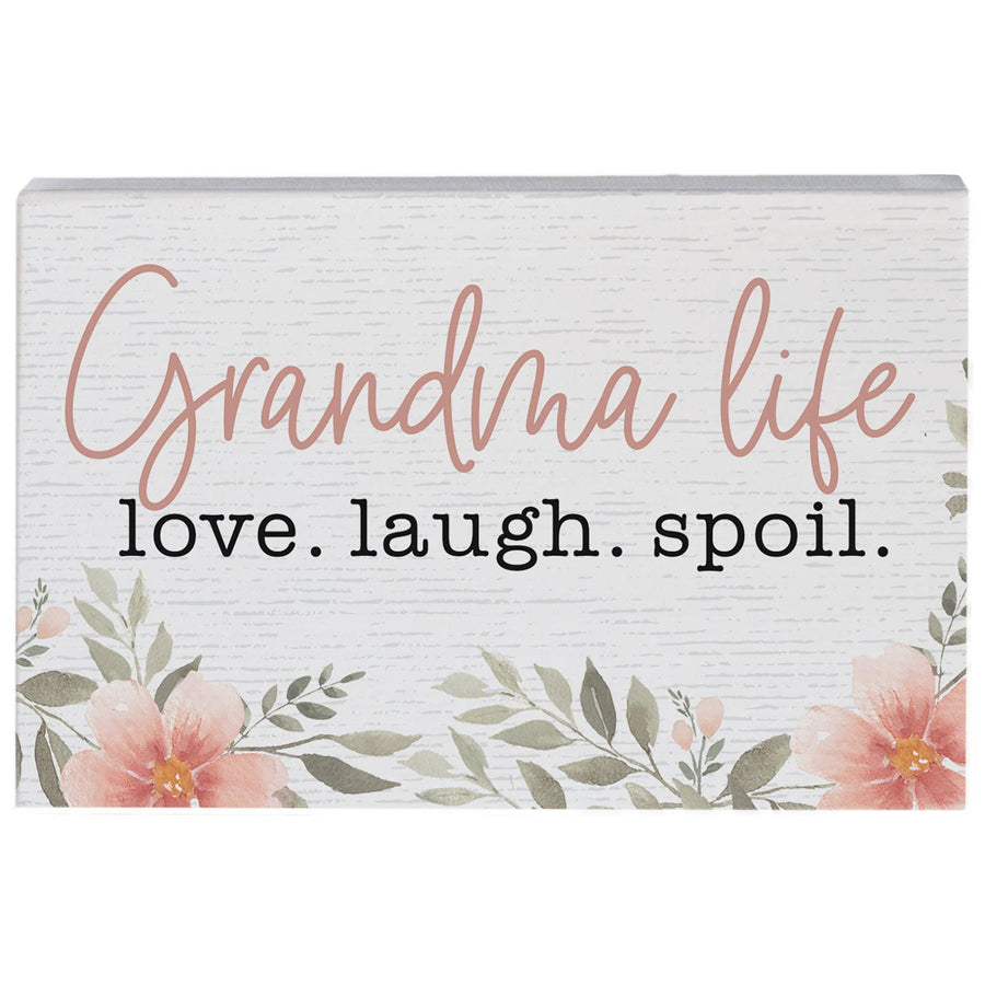 Decorative sign with 'Grandma life love. laugh. spoil.' text and floral design on a white background
