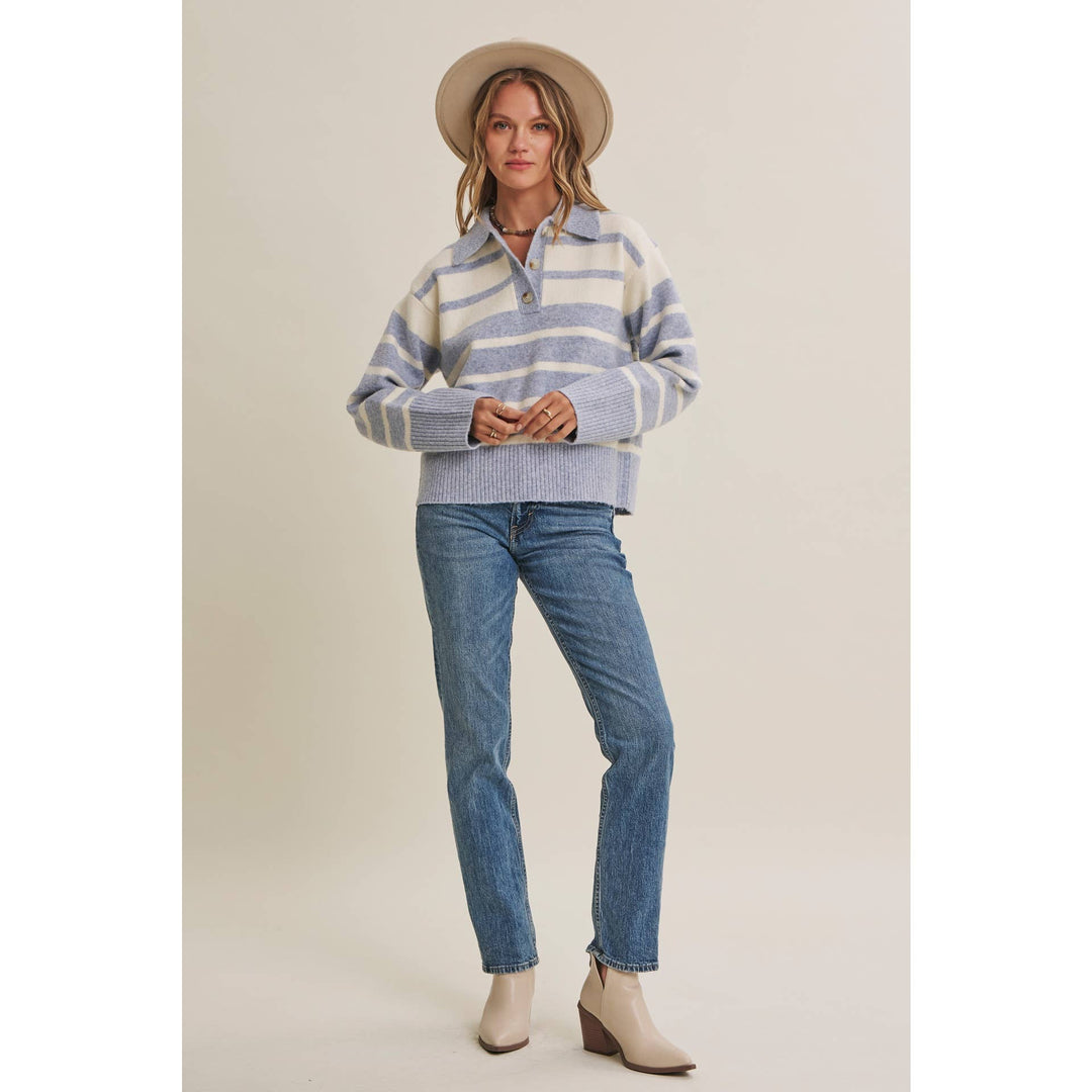Woman wearing The Marlowe ice blue and ivory striped brushed Henley sweater with blue jeans
