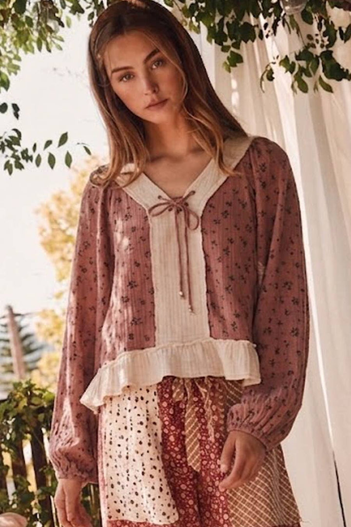 Dusty rose floral print long sleeve top with cream cotton gauze V-neck tie detail and ruffled hem