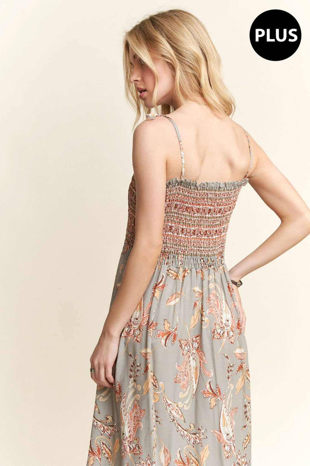 Plus size boho maxi dress with paisley pattern, smocked bodice, and flowy hemline.

