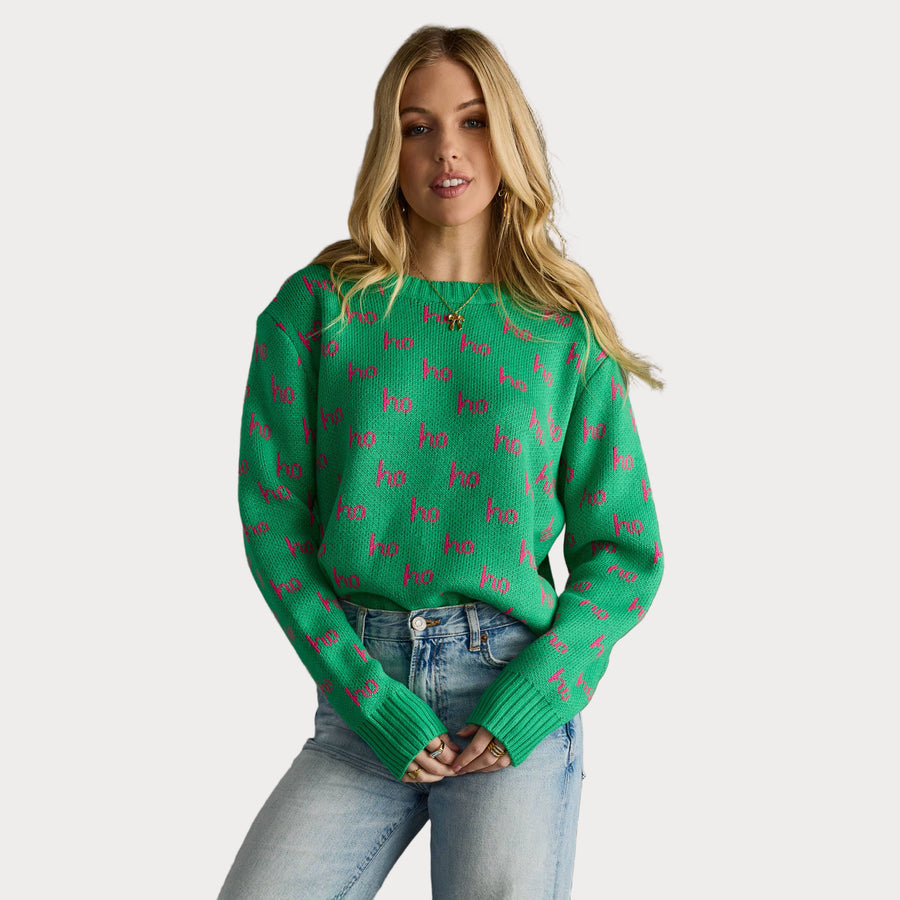 Green holiday sweater with pink “ho ho ho” text, long sleeves, and crew neckline.