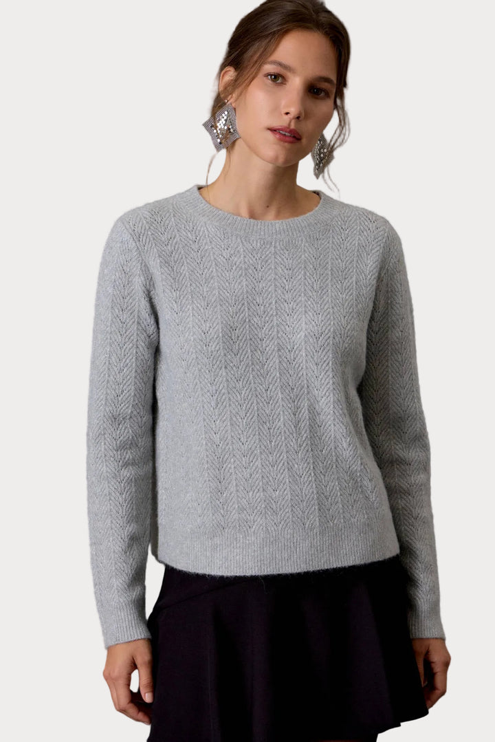 Be Cool Shimmering Moments light gray glitter pointelle knit sweater with crew neck, long sleeves, and relaxed cropped fit.