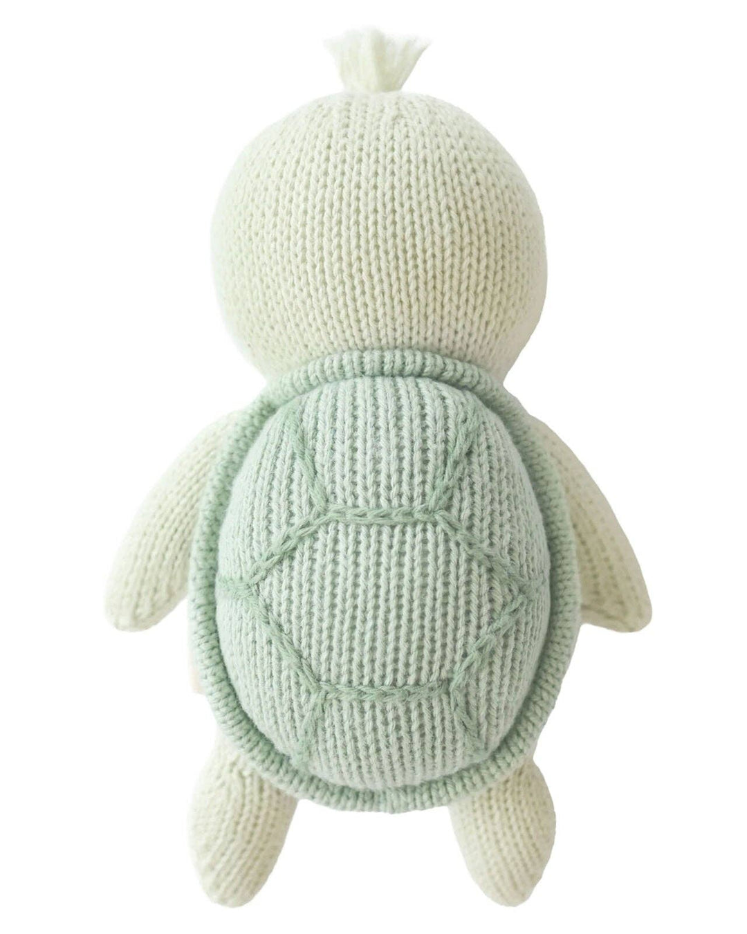 Knitted turtle toy with a light green shell on a white background