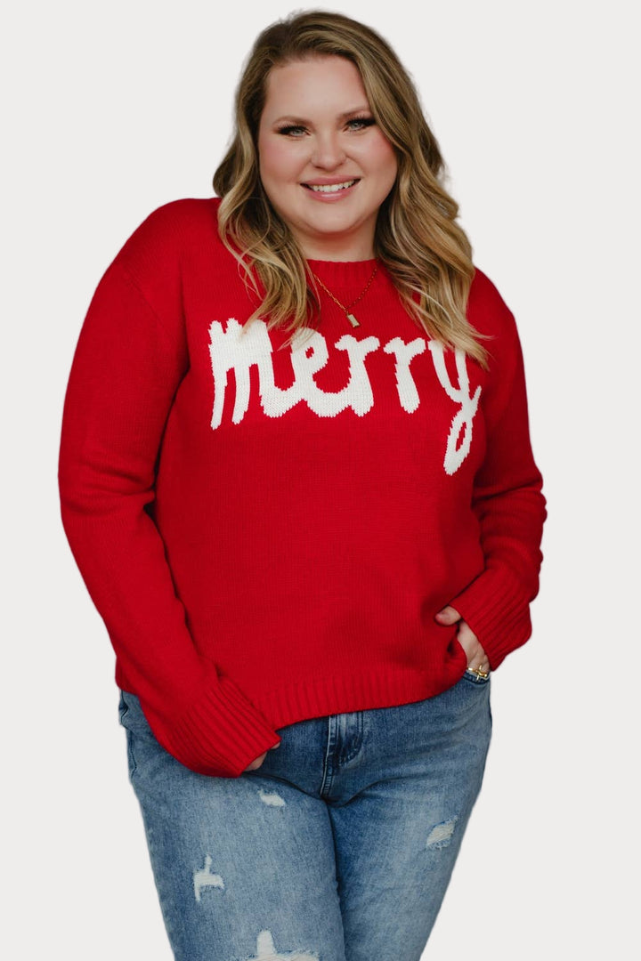Plus size model wearing a red sweater with 'merry' text against a neutral background