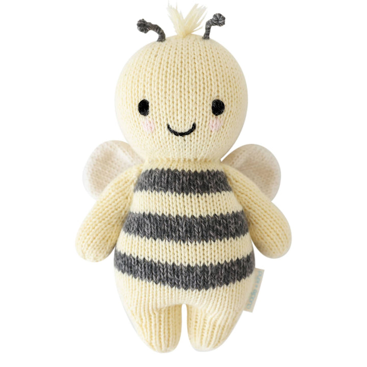Knitted bee toy with a white background
