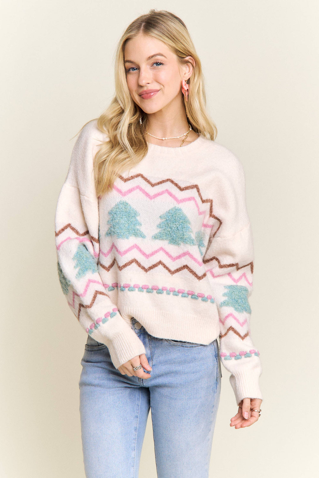 “Cream knit sweater with fluffy textured Christmas trees and pastel chevron stripes”