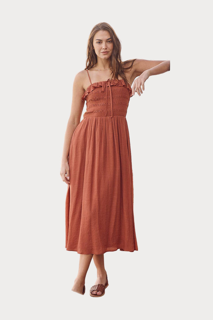 Woman wearing a rust-colored dress on a white background