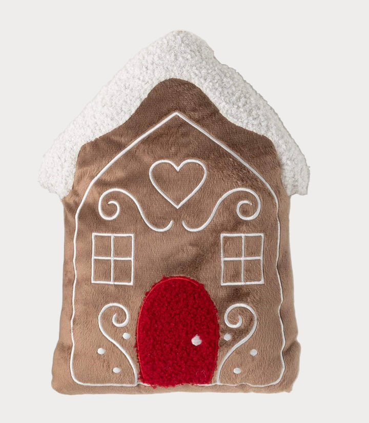 Plush gingerbread house pillow with red door and snowy white roof