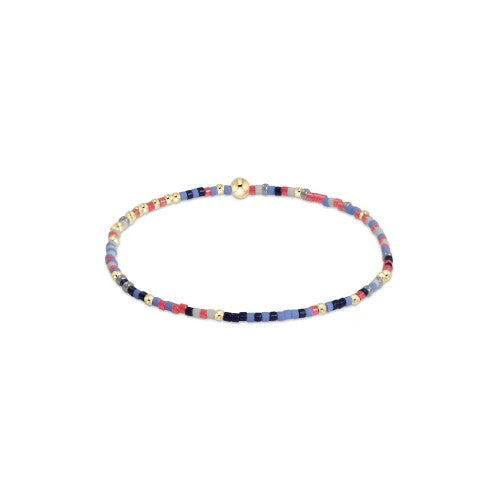 Navy, coral, and light blue beaded bracelet with 14kt gold accents on elastic band