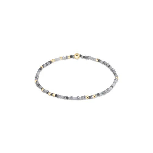 Gray and gold beaded bracelet on elastic band with minimalist design