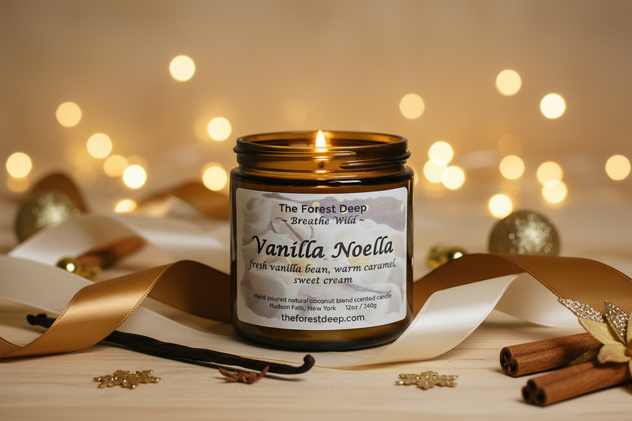 Vanilla scented candle labeled 'Vanilla Noella' with vanilla beans and cinnamon sticks on a wooden surface with blurred lights in the background.