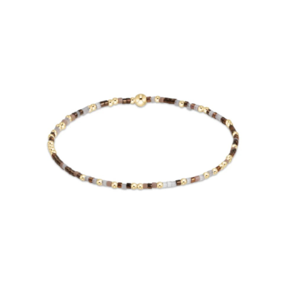 Brown and gold beaded bracelet with soft taupe tones on elastic band